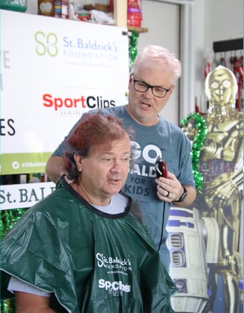 Man shaving Jeff Parker's head